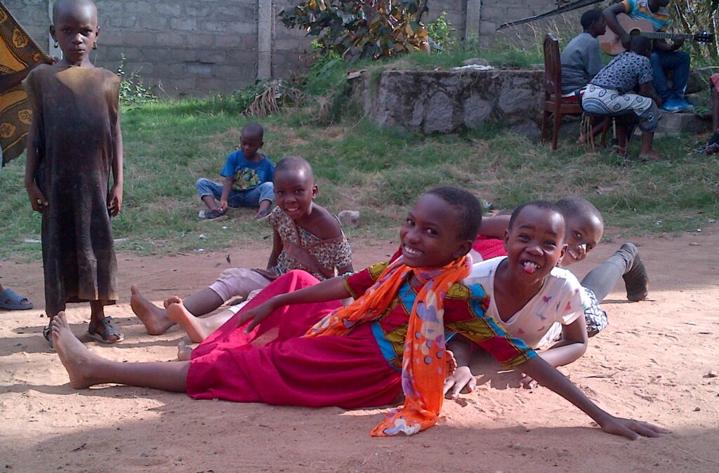 Photograph of children sitting outside.